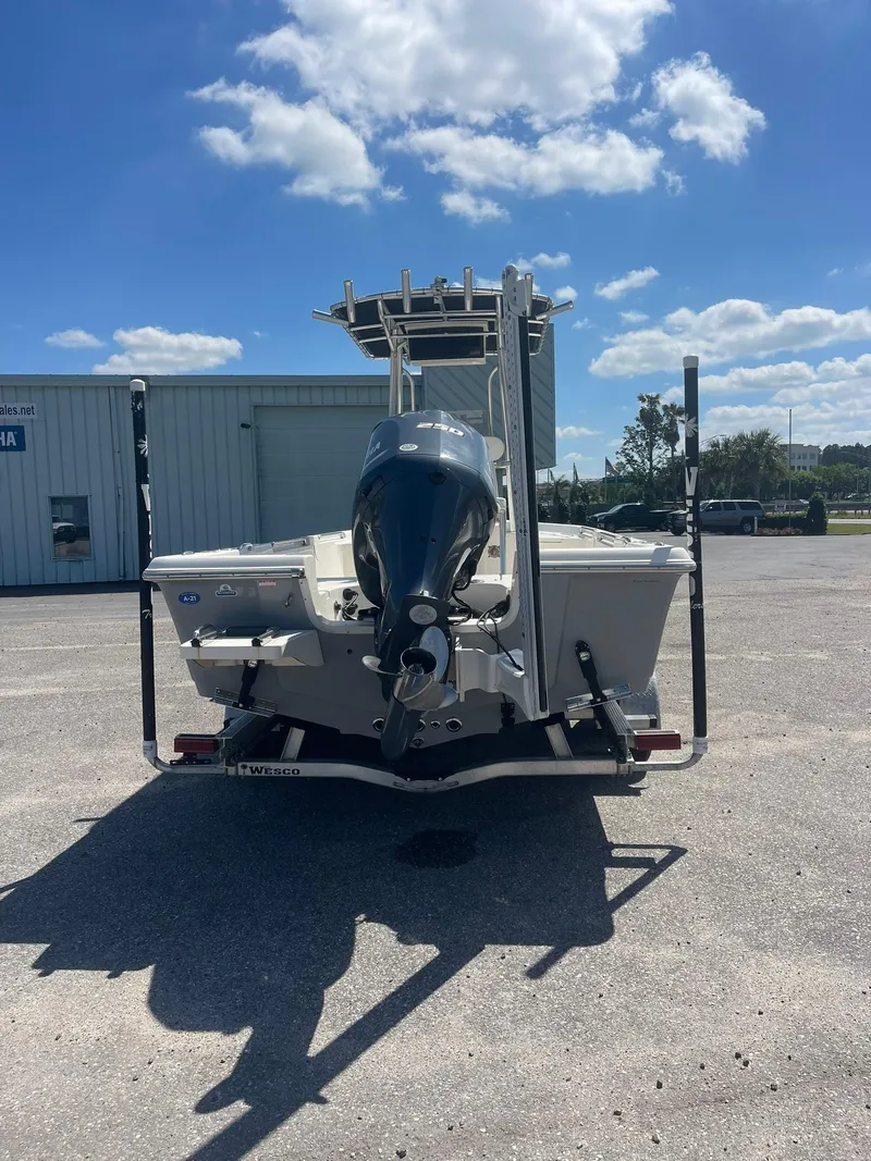 Slide: The Image of 2020 Bulls Bay 2400 boat with outboard motor, parked outdoors under a clear blue sky. - 3