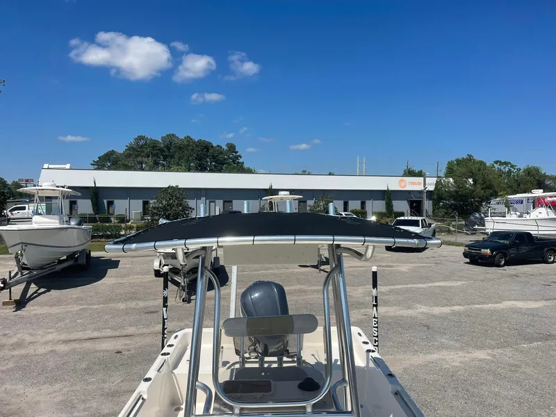 Slide: The Image of 2020 Bulls Bay 2400 boat with T-top in a parking lot under a clear blue sky. - 7