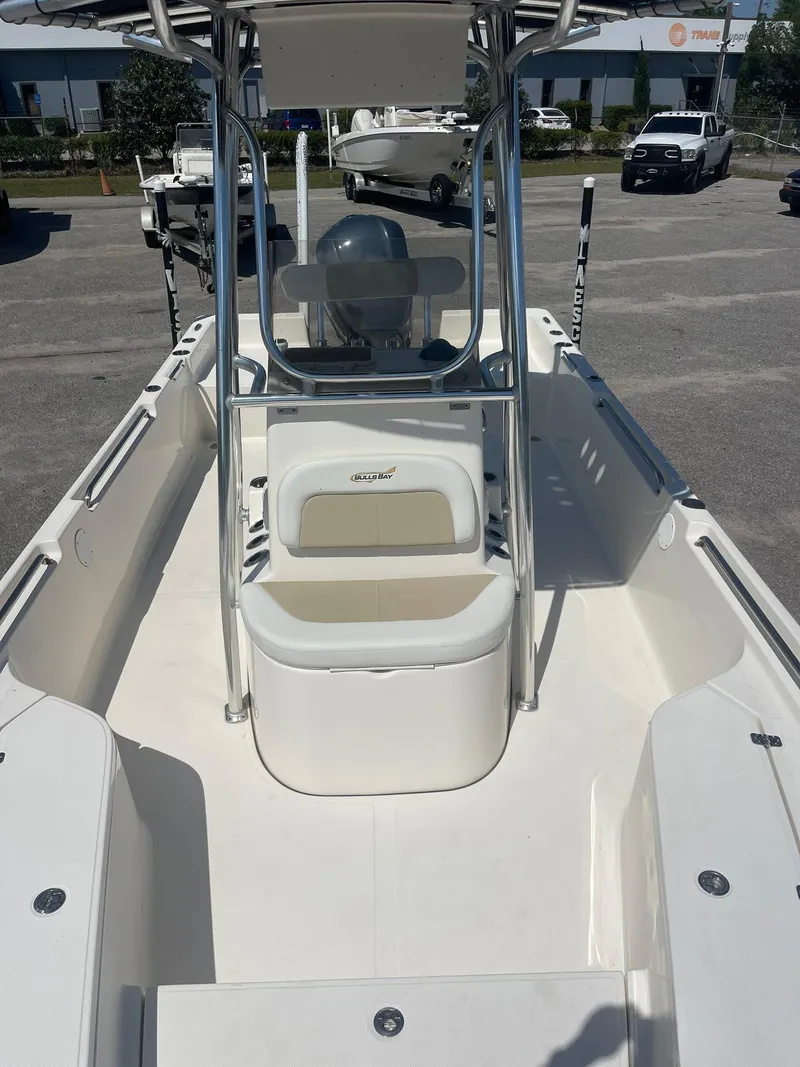 Slide: The Image of 2020 Bulls Bay 2400 boat, spacious deck, center console, parked outdoors. - 8