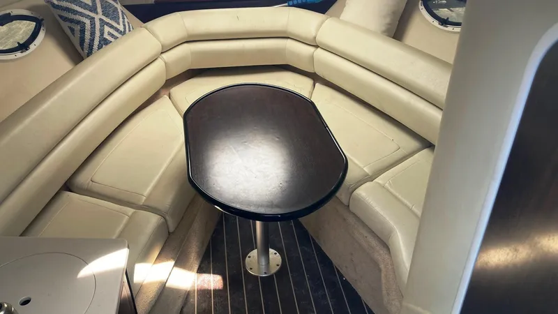 Slide: The Image of 2018 Monterey 275 Sport Yacht interior with beige seating and central table. - 11