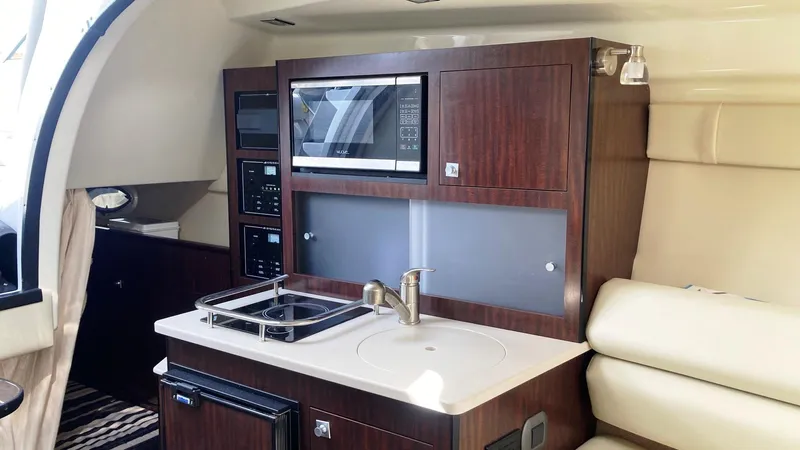 Slide: The Image of Interior of 2018 Monterey 275 Sport Yacht with kitchenette and modern amenities. - 13