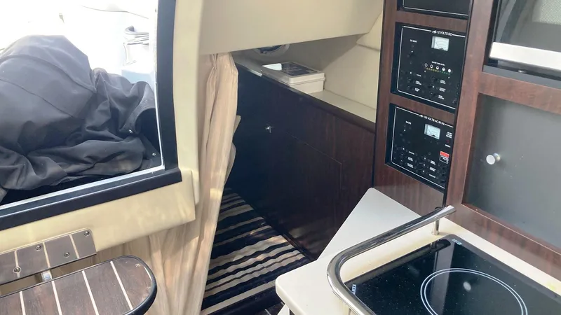 Slide: The Image of Interior of 2018 Monterey 275 Sport Yacht with kitchen and control panels. - 15