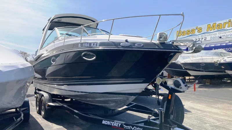 Slide: The Image of 2018 Monterey 275 Sport Yacht on trailer at marina, side view. - 2