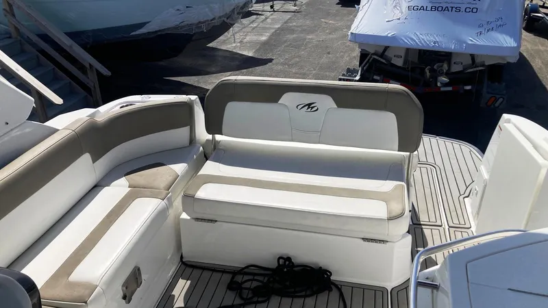 Slide: The Image of 2018 Monterey 275 Sport Yacht interior with beige and white seating on deck. - 4