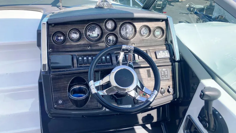 Slide: The Image of 2018 Monterey 275 Sport Yacht dashboard with steering wheel and instrument panel. - 8