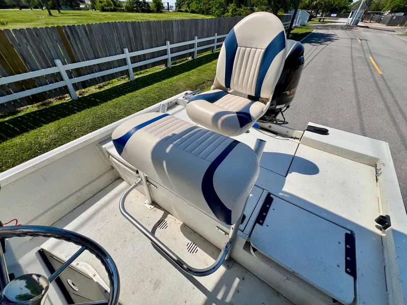 Slide: The Image of 2019 G3 Bay 20 DLX boat interior with cushioned seating and steering wheel. - 10