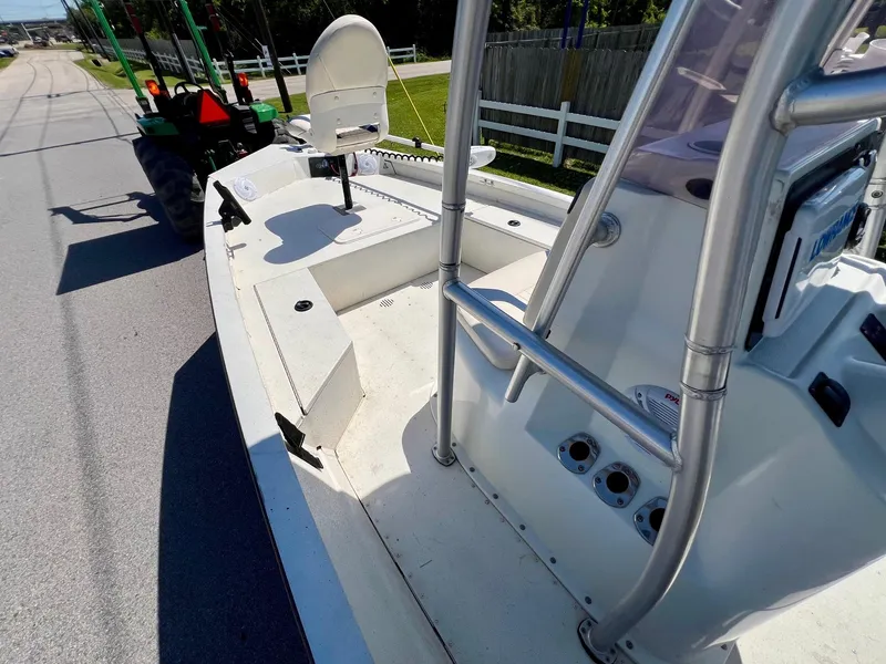 Slide: The Image of 2019 G3 Bay 20 DLX boat on road, featuring spacious deck and seating. - 13