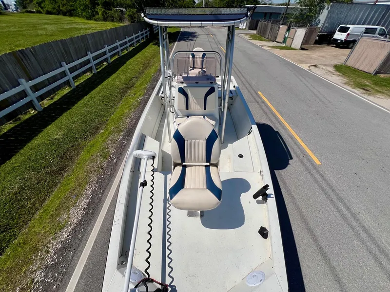 Slide: The Image of 2019 G3 Bay 20 DLX boat on road, featuring seating and console. - 16