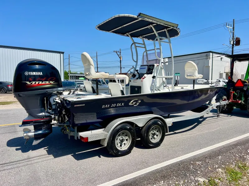 Slide: The Image of 2019 G3 Bay 20 DLX boat on trailer with Yamaha VMAX engine, parked outdoors. - 4