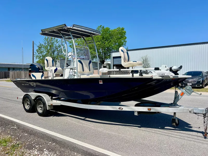 Slide: The Image of 2019 G3 Bay 20 DLX boat on trailer, parked outdoors under clear blue sky. - 5