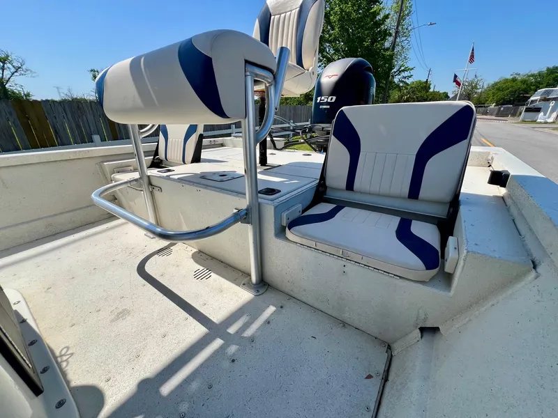 Slide: The Image of 2019 G3 Bay 20 DLX boat interior with seating and motor, outdoors. - 7