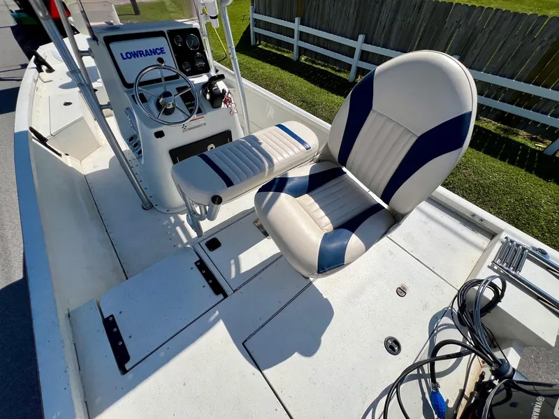 Slide: The Image of 2019 G3 Bay 20 DLX boat interior with steering console and cushioned seating. - 9