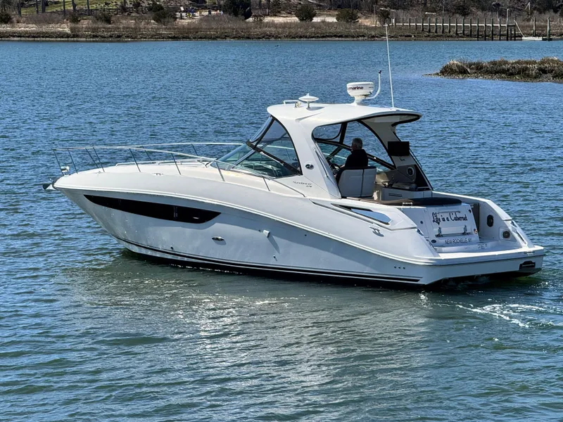 Slide: The Image of 2014 Sea Ray 370 Sundancer cruising on calm waters. - 0