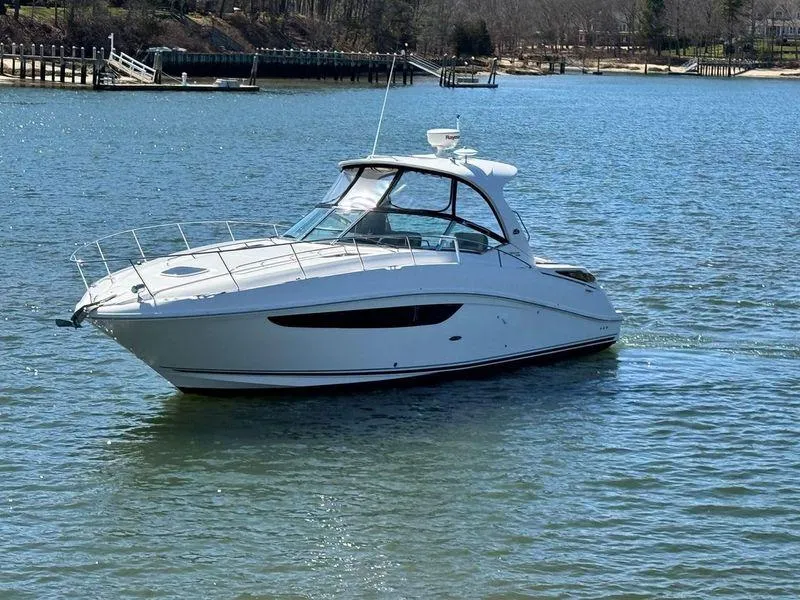 Slide: The Image of 2014 Sea Ray 370 Sundancer yacht on calm water, showcasing sleek design and luxury features. - 1