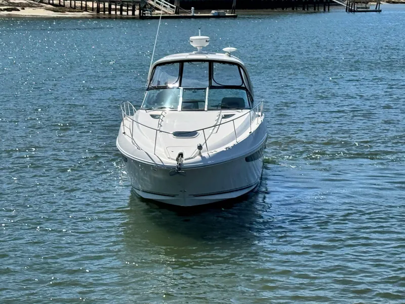 Slide: The Image of 2014 Sea Ray 370 Sundancer yacht on calm water, front view. - 10