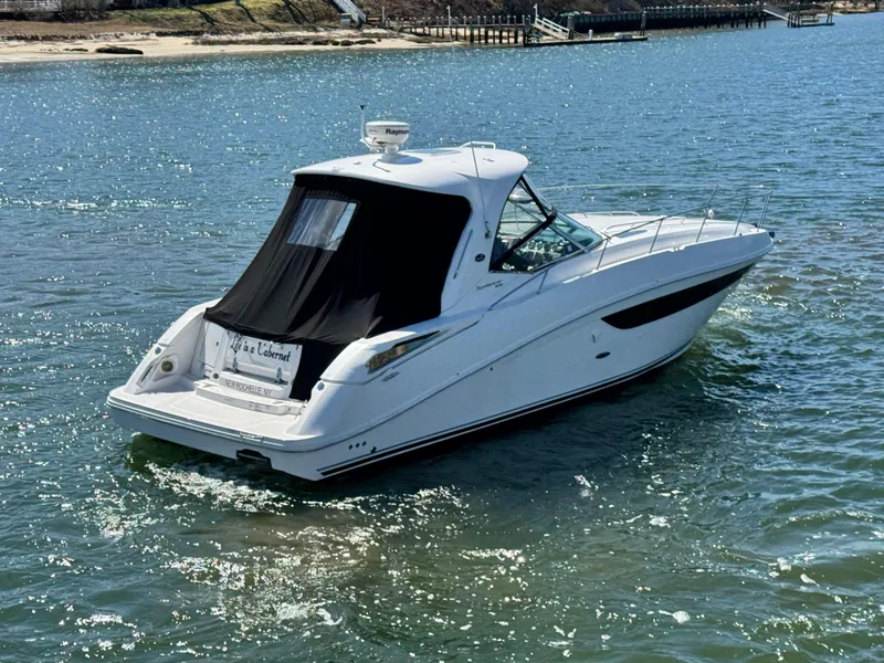 Slide: The Image of 2014 Sea Ray 370 Sundancer cruising on a sunny day in calm waters. - 12