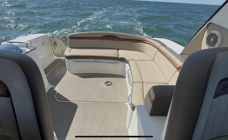 Slide: The Image of 2014 Sea Ray 370 Sundancer boat interior with beige seating on open water. - 18