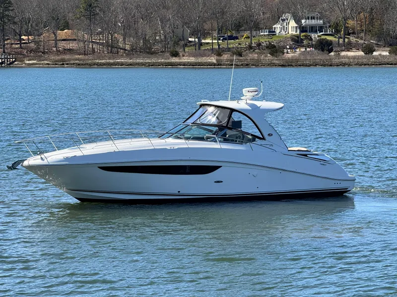 Slide: The Image of 2014 Sea Ray 370 Sundancer yacht cruising on a serene lake. - 2