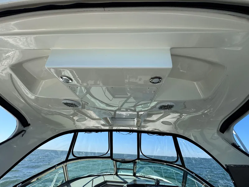 Slide: The Image of 2014 Sea Ray 370 Sundancer boat interior with ocean view through windows. - 25