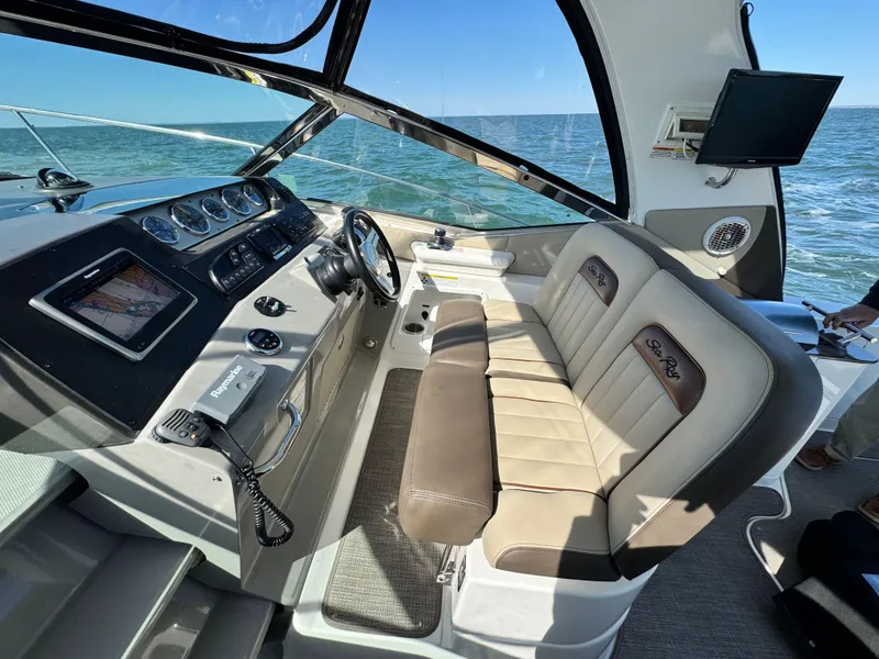 Slide: The Image of 2014 Sea Ray 370 Sundancer cockpit with leather seating and ocean view. - 28