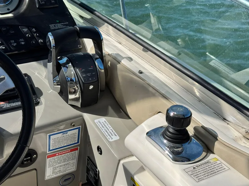 Slide: The Image of Control panel of a 2014 Sea Ray 370 Sundancer boat with throttle and joystick. - 29