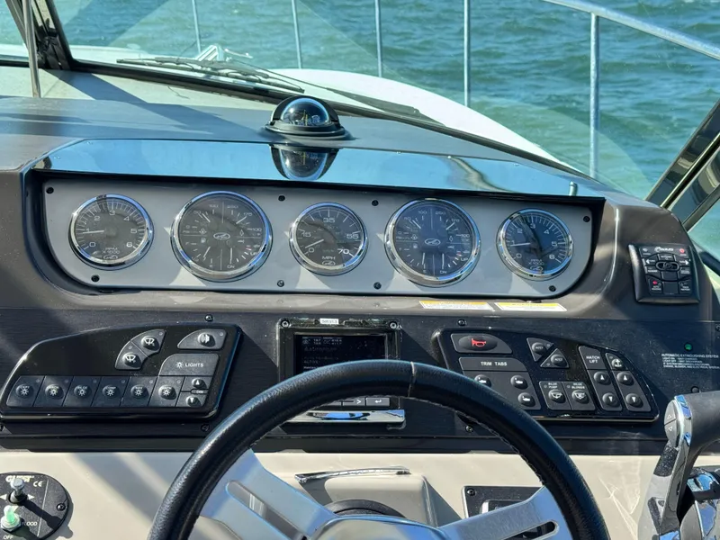 Slide: The Image of Control panel of a 2014 Sea Ray 370 Sundancer boat with gauges and steering wheel. - 30