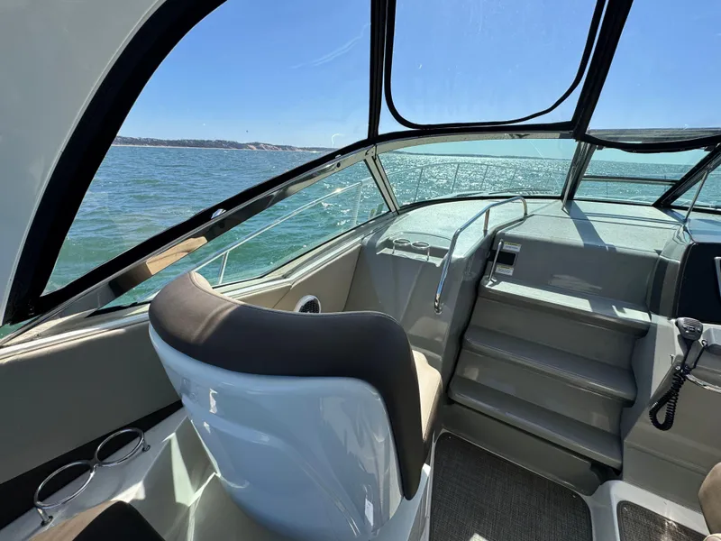 Slide: The Image of 2014 Sea Ray 370 Sundancer helm with ocean view, featuring modern design and comfortable seating. - 33