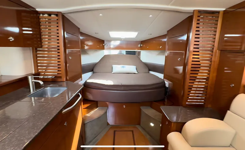 Slide: The Image of Luxurious interior of 2014 Sea Ray 370 Sundancer yacht with bed and kitchenette. - 36