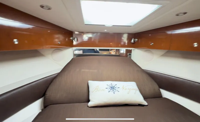 Slide: The Image of 2014 Sea Ray 370 Sundancer cabin with skylight and "Bon Voyage" pillow. - 37