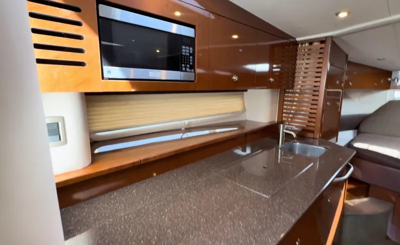 Slide: The Image of Luxurious interior of 2014 Sea Ray 370 Sundancer yacht with modern kitchen amenities. - 39