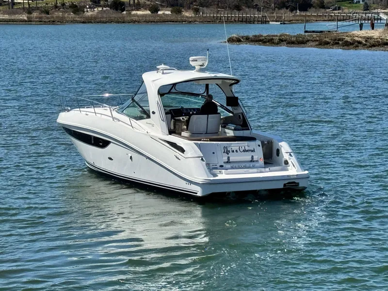 Slide: The Image of 2014 Sea Ray 370 Sundancer cruising on a calm lake. - 4