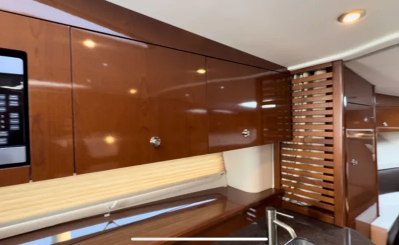 Slide: The Image of Interior of 2014 Sea Ray 370 Sundancer with sleek wooden cabinetry and modern design. - 40