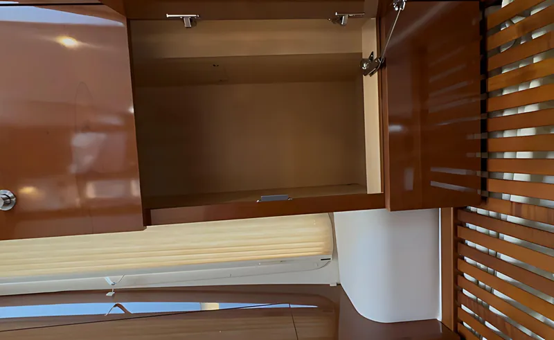 Slide: The Image of Open wooden cabinet inside 2014 Sea Ray 370 Sundancer yacht interior. - 42
