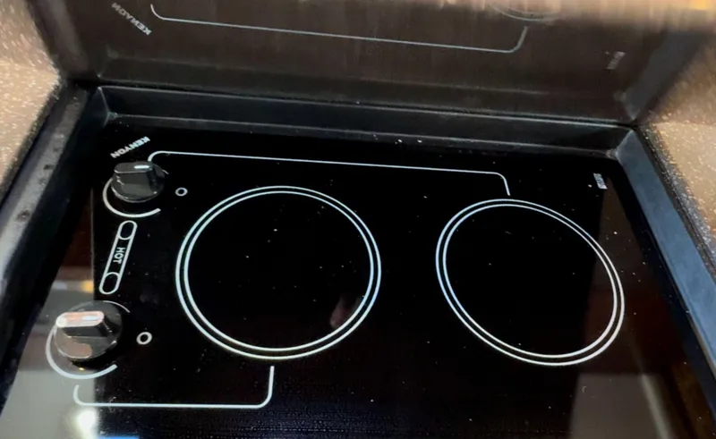 Slide: The Image of Stovetop on 2014 Sea Ray 370 Sundancer yacht, featuring dual burners and sleek design. - 45