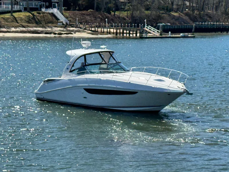 Slide: The Image of 2014 Sea Ray 370 Sundancer yacht cruising on a sunny day in a serene waterway. - 6