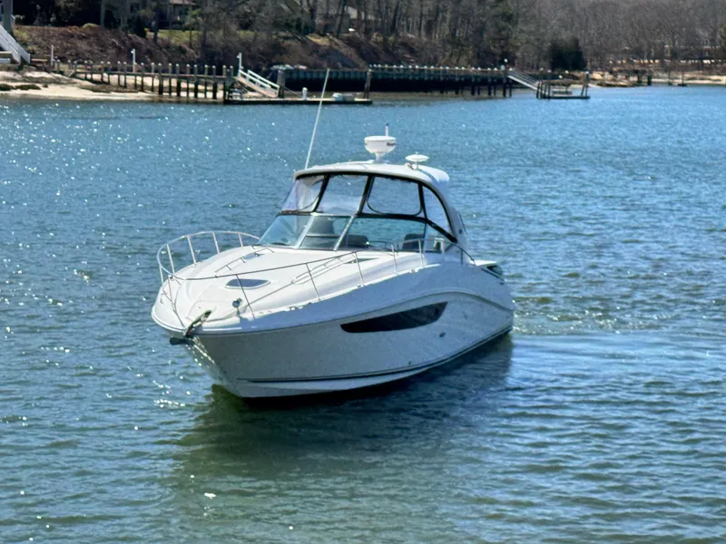 Slide: The Image of 2014 Sea Ray 370 Sundancer cruising on a serene lake. - 7