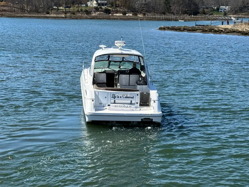 Slide: The Image of 2014 Sea Ray 370 Sundancer cruising on a serene lake. - 9