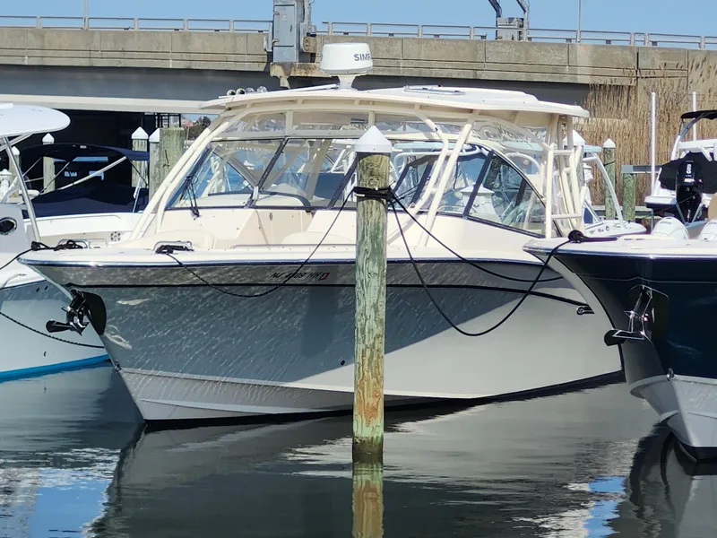 Slide: The Image of 2016 Grady-White Freedom 335 boat docked in marina, front view. - 0