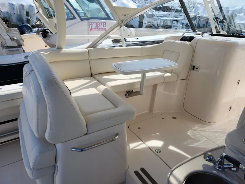 Slide: The Image of 2016 Grady-White Freedom 335 boat interior with white seating and table. - 11