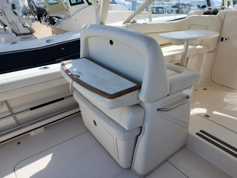 Slide: The Image of 2016 Grady-White Freedom 335 boat interior with seating and table. - 12