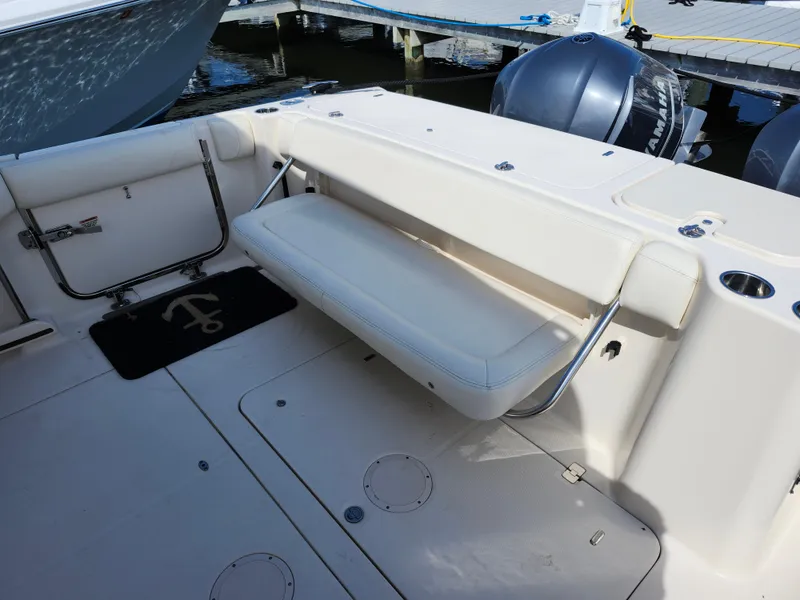 Slide: The Image of 2016 Grady-White Freedom 335 boat with foldable seating and twin engines at dock. - 14