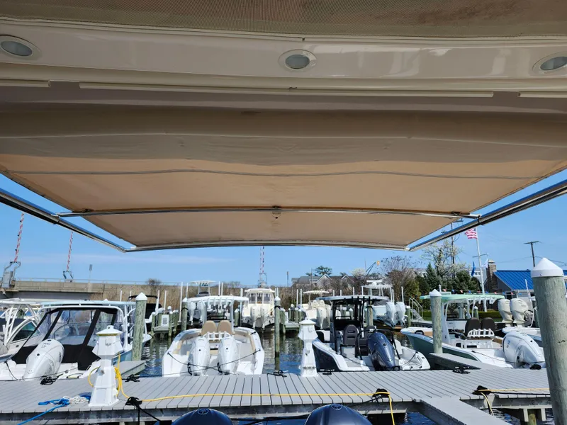Slide: The Image of 2016 Grady-White Freedom 335 boat docked at marina, view from under canopy. - 18