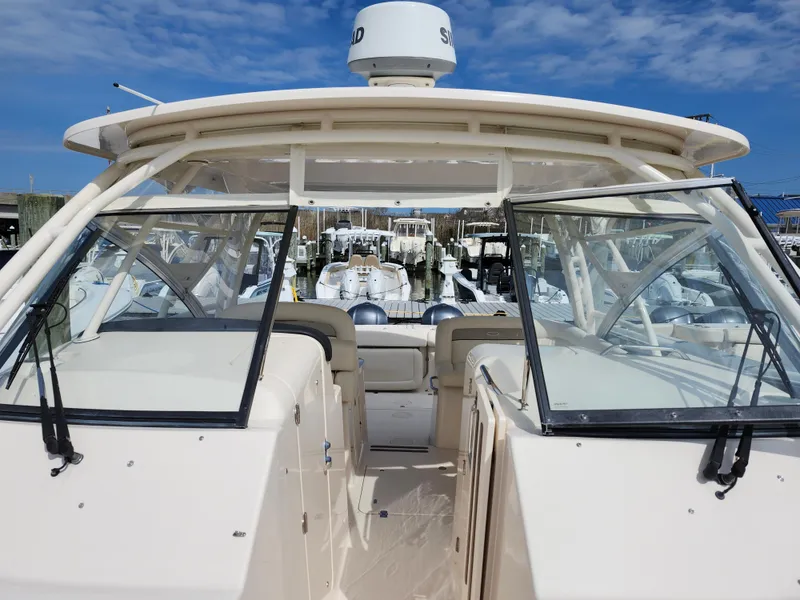 Slide: The Image of 2016 Grady-White Freedom 335 boat with open cockpit and clear skies. - 22