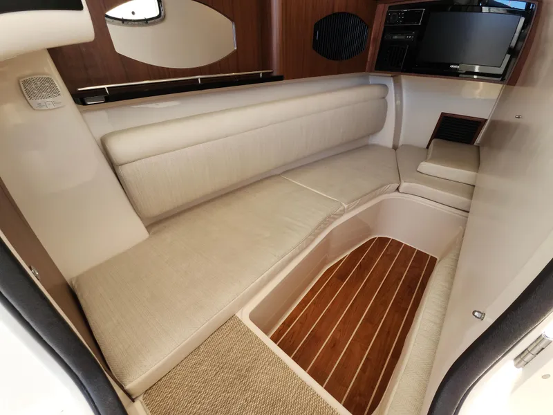 Slide: The Image of Interior of 2016 Grady-White Freedom 335 boat with beige seating and wood flooring. - 23