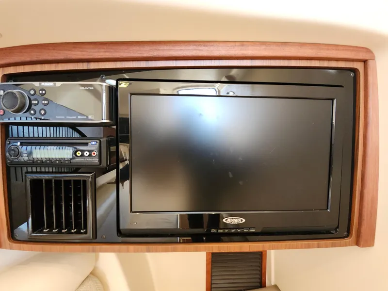 Slide: The Image of 2016 Grady-White Freedom 335 boat interior with built-in entertainment system and control panel. - 26