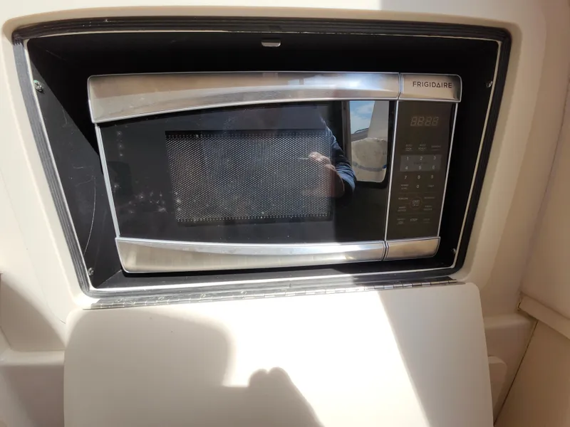 Slide: The Image of Frigidaire microwave in 2016 Grady-White Freedom 335 boat interior. - 27