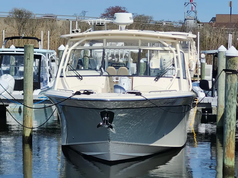 Slide: The Image of 2016 Grady-White Freedom 335 boat docked in marina, front view. - 3