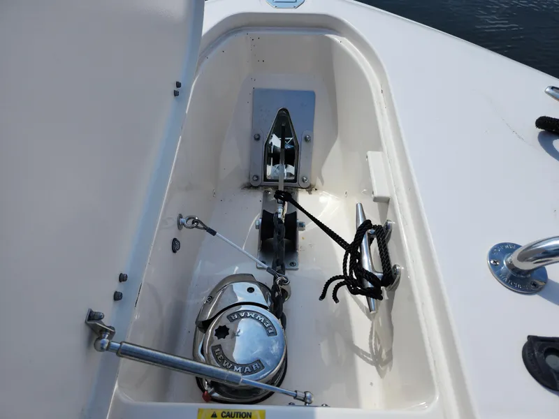 Slide: The Image of 2016 Grady-White Freedom 335 boat anchor compartment with winch and rope. - 30