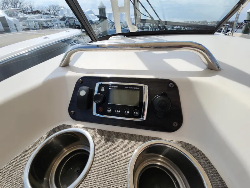 Slide: The Image of 2016 Grady-White Freedom 335 boat dashboard with stereo system and cup holders. - 31