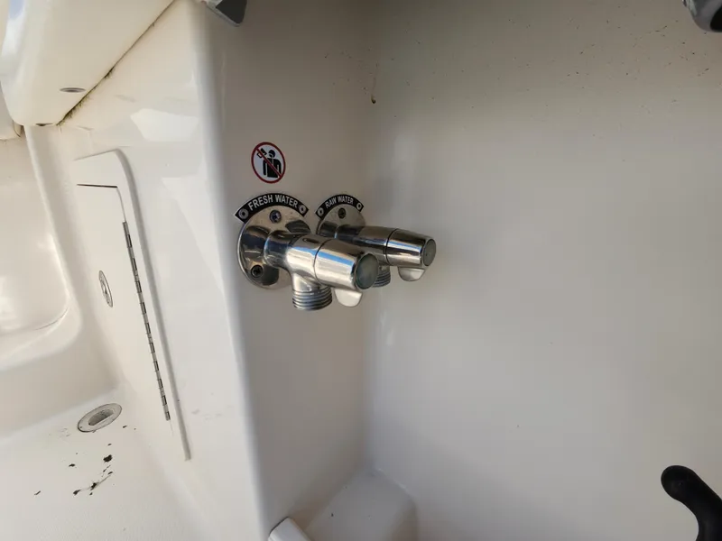 Slide: The Image of 2016 Grady-White Freedom 335 boat water outlets, labeled for fresh and raw water. - 33